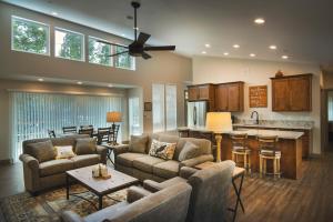 a living room with couches and a kitchen at 11R Spring Meadow Retreat in Wawona