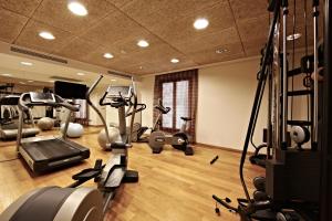 a gym with several treadmills and machines in it at Petit Palace Hotel Tres in Palma de Mallorca