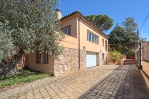 a brick driveway in front of a house at 5 bedroom house in Begur with private pool and garden (Ref.H53) in Begur