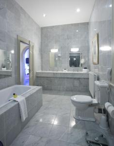 a bathroom with a toilet, sink and tub at The Culloden Estate and Spa in Belfast