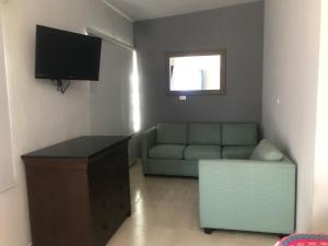 sala de estar con sofá y TV en Casa Paraiso de Kino en Bahía Kino