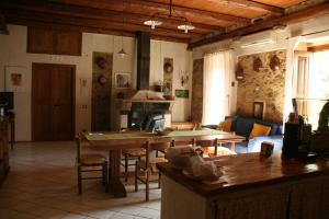 a kitchen and living room with a table and a couch at Rosacanina B&B in Torchiara