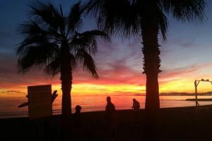 a group of people walking on the beach at sunset at Eldorado Yurt in Algarrobo +11 photos