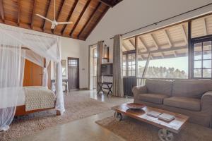 a living room with a bed and a couch at The Postcard Galle in Galle +144 photos