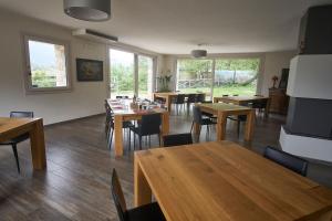 a dining room with wooden tables and chairs at Agriturismo CasaMela in Paderno del Grappa