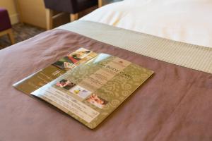 a invitation to a wedding on a bed at Hotel Monterey Grasmere Osaka in Osaka