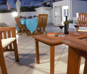 a table with two glasses of wine on a patio at Near The Port Apartment in Cala Gonone