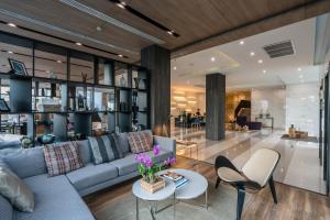 a living room with a couch and chairs at The Residence on Thonglor by UHG in Bangkok