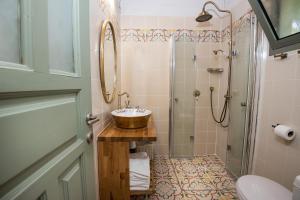 a bathroom with a sink and a shower at Sea of Galilee Panoramic View in Moshav Ramot