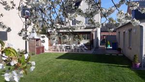 a garden with white flowers on the grass at Le Gîte du Magnolia in Willerval