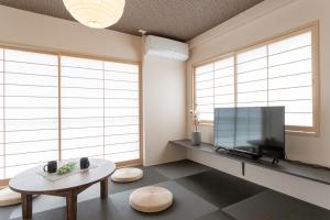 a living room with a tv and a table at Sakura Stay Yoga 301 in Tokyo