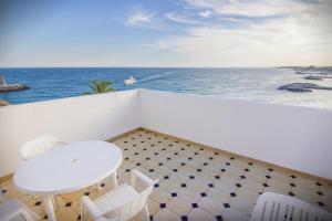 
a beach scene with a balcony overlooking the ocean at Park Plaza Suites Apartamentos in Marbella
