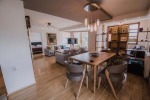 a dining room and living room with a table and chairs at Exclusive Apartments Bistrik in Sarajevo