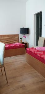 a bedroom with two beds and a table and chairs at Pension Haus Baron 1 Neckarau in Mannheim