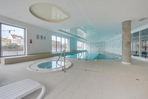 a large bathroom with two jacuzzi tubs at Waterlane Island - Riverview Pool, SPA, Gym & Parking by Downtown Apartments in Gdańsk