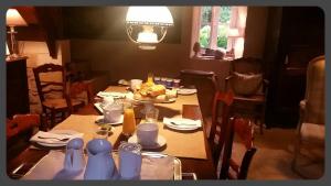 a dining room table with a plate of food on it at manoir du Rieu in Saint-Geniès