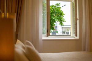 Posteľ alebo postele v izbe v ubytovaní Salvator Boutique Hotel vegan-friendly