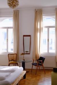 a room with a bed, chair and a window at Hotel Am Brillantengrund in Vienna