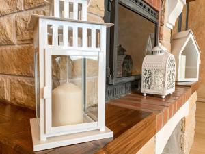 two white lanterns and a vase on a shelf at City Inn Riga Apartment, Old Town History Heritage with parking in Rīga