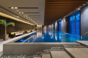 a swimming pool in a hotel lobby at Marco Polo Ortigas Manila in Manila