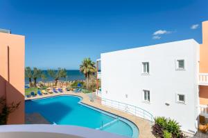 a view of a swimming pool next to a building at Eden Beach Hotel in Agia Marina Nea Kydonias