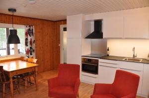 a kitchen and dining room with a table and chairs at Stuga 5 Varmland in Torsby