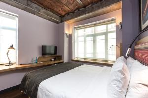 a bedroom with a white bed and two windows at Bankerhan Hotel Galata - Adults Only Special Category in Istanbul