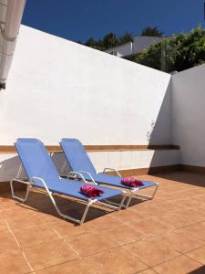 two blue lounge chairs sitting on a patio at Apartamento Girasol in Ardales