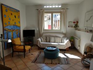 a living room with a couch and a window at La Forge in Signes
