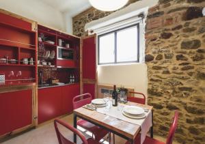 a dining room with a table and chairs and a brick wall at Torre di Baratti Bio Resort in Populonia