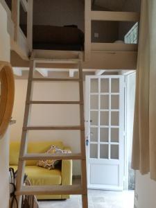 a bunk bed in a room with a ladder and a door at L'Orgalière Alpilles in Orgon +33 photos