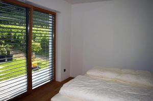 a bedroom with a bed and a large window at Weingut Bachgütl in Cermes +25 photos