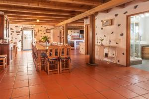 a kitchen and dining room with a table and chairs at Aldeia da Cuada in Faja Grande