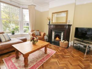 a living room with a coffee table and a fireplace at 8 Wilton Road in Hornsea