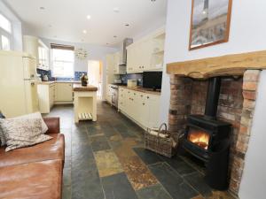 a kitchen with a brick fireplace in a living room at 8 Wilton Road in Hornsea