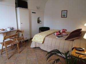 1 dormitorio con cama, mesa y escritorio en Puesta De Sol, en Tramonti