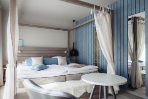 a bedroom with a bed and a chair at Original Sokos Hotel Arina Oulu in Oulu
