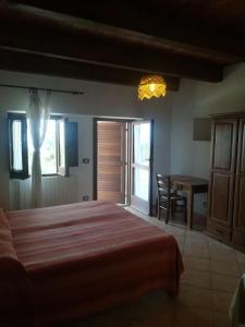a bedroom with a bed and a dining room with a table at Agriturismo Acampora in Cerchiara di Calabria