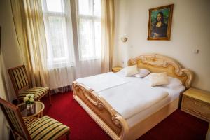 Postel nebo postele na pokoji v ubytování Hotel Dejmalik