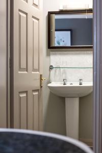 a bathroom with a sink and a mirror at White Hart by Chef & Brewer Collection in Chalfont Saint Giles