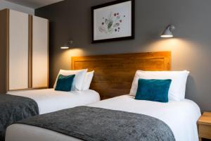 a hotel room with two beds and two lamps at White Hart by Chef & Brewer Collection in Chalfont Saint Giles