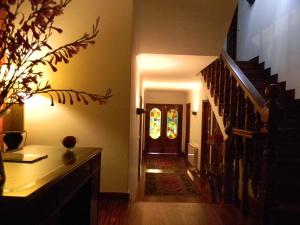 a hallway with a staircase and a door with a stained glass window at Pazo Carrasqueira in Ribadumia