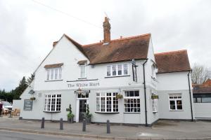 a white building on the corner of a street at White Hart by Chef & Brewer Collection in Chalfont Saint Giles