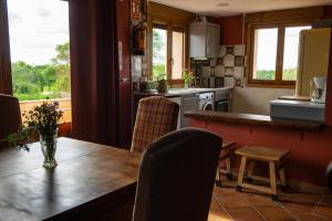 a kitchen with a table and chairs and a counter at Las Casitas de la Data in Gallegos +18 photos
