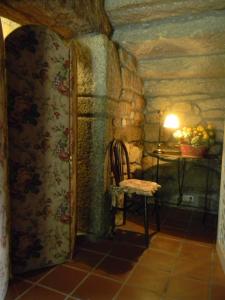 a room with a refrigerator and a table with a bowl of fruit at Pazo Carrasqueira in Ribadumia