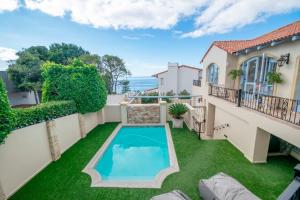 a swimming pool in the yard of a house at Lavender hill in Plettenberg Bay
