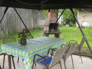 a table and chairs with a table and a fireplace at Country House Aleš in Gornja Bistrica +13 photos