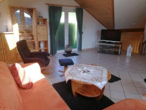 a living room with a couch and a table at Ferienwohnung Gross B in Schleiden