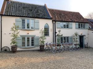 a group of bikes parked in front of a house at Holly Lodge Boutique B&B in Thursford