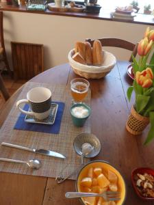 a table with a bowl of bread and a bowl of fruit at le rocher de Sampzon in Sampzon +40 photos